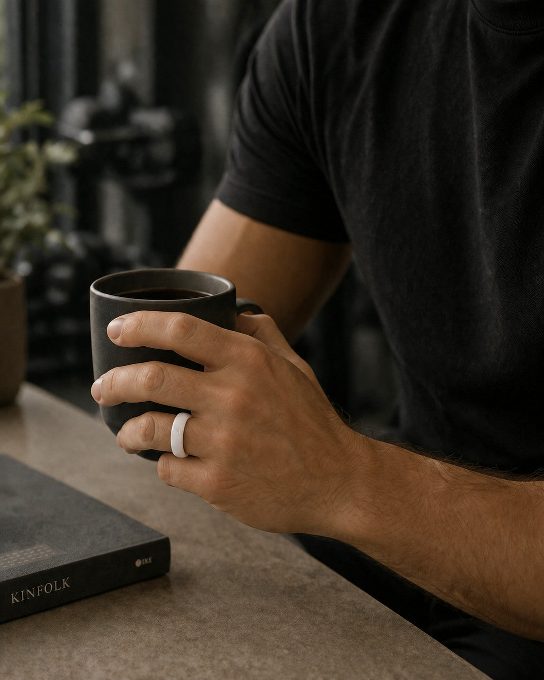 Kayza PRO white smart ring worn while holding a coffee cup
