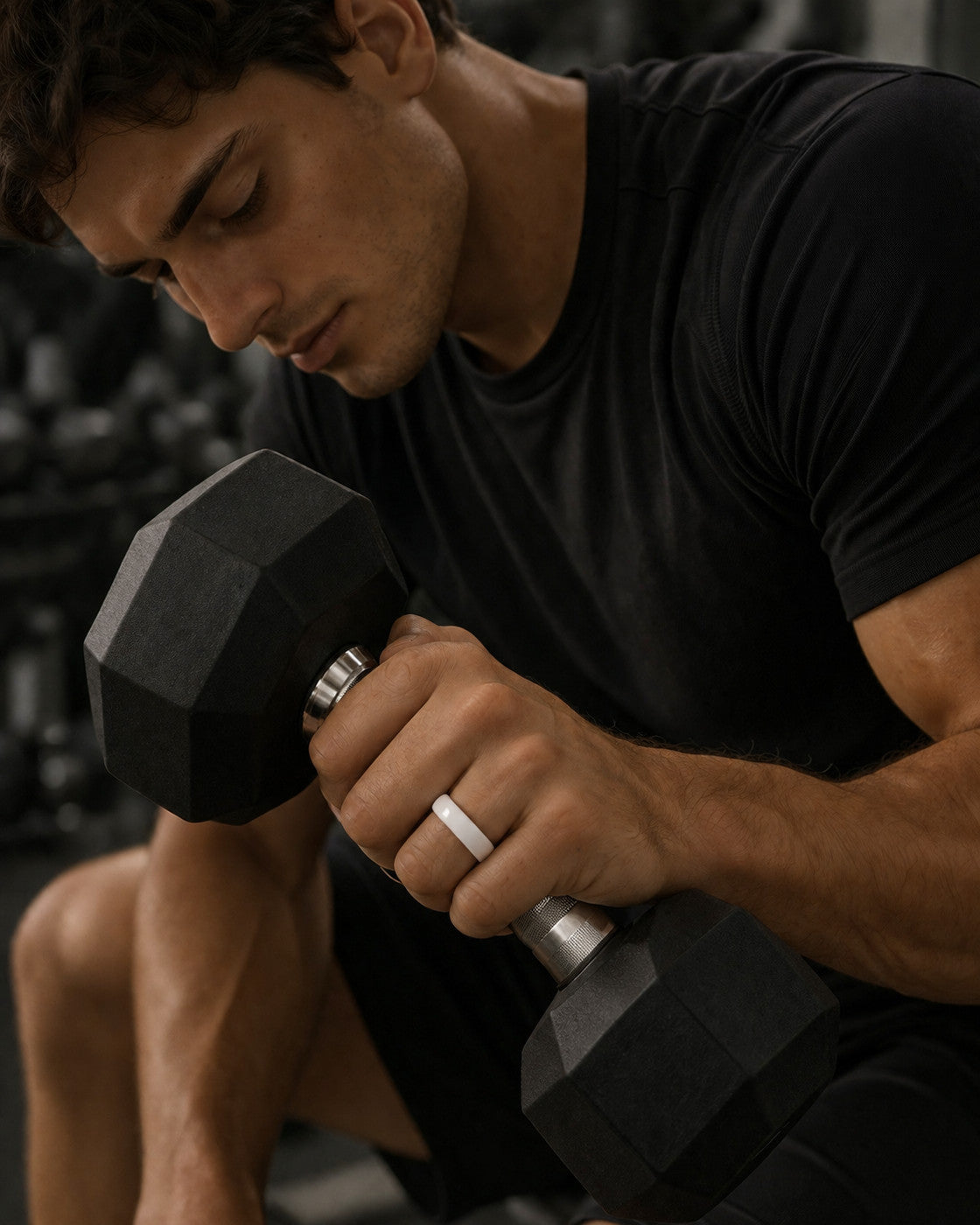 Kayza PRO white smart ring worn during dumbbell training in the gym